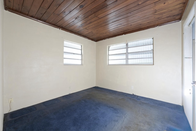 unfurnished room featuring wood ceiling and crown molding