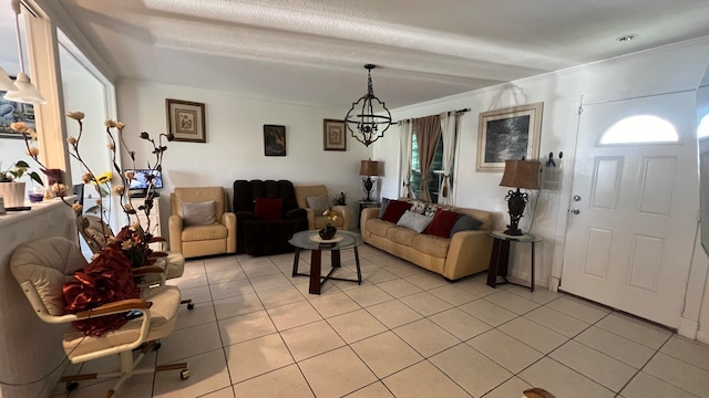 tiled living room with ornamental molding and a notable chandelier