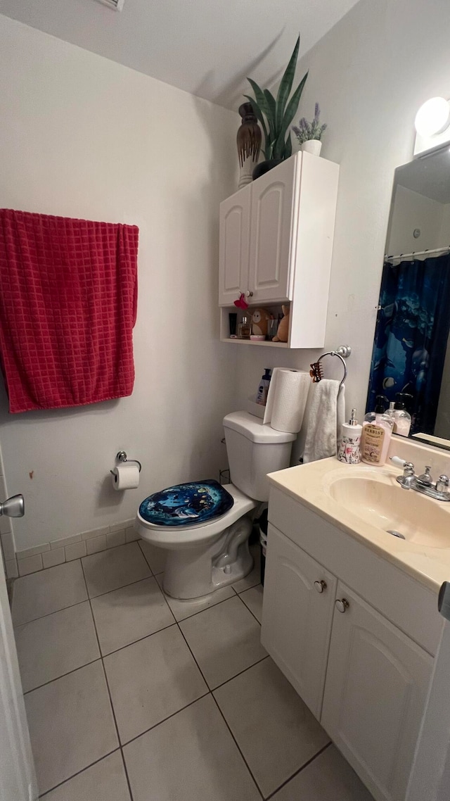 bathroom with vanity, tile patterned flooring, and toilet