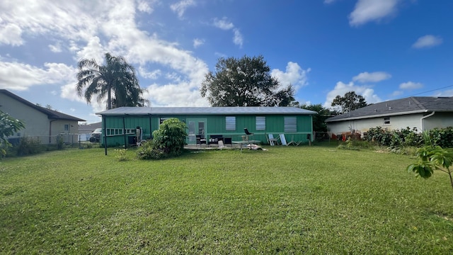 rear view of house with a patio area and a yard