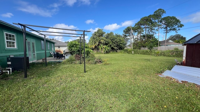 view of yard featuring central AC unit and a patio