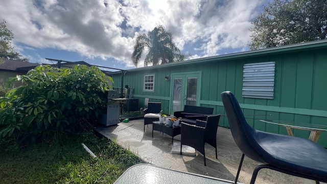 back of property with a patio, central air condition unit, and an outdoor hangout area