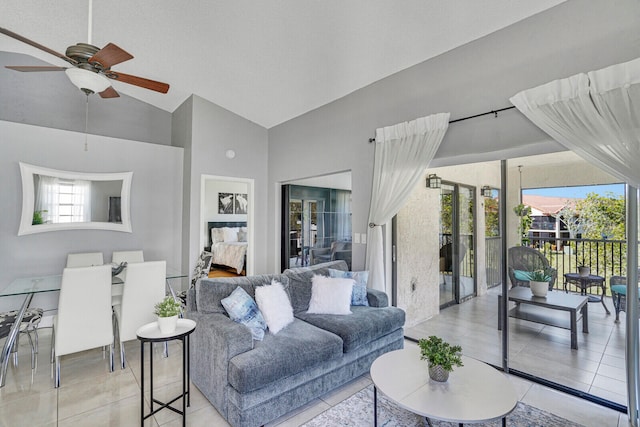 tiled living room featuring high vaulted ceiling and ceiling fan