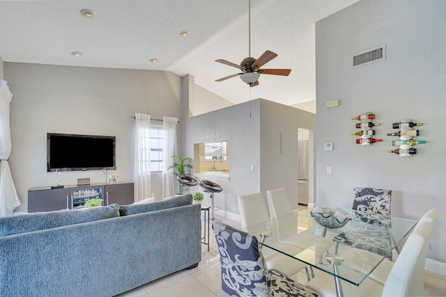 living room featuring light tile patterned flooring, a textured ceiling, high vaulted ceiling, and ceiling fan