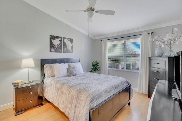 bedroom with ceiling fan, ornamental molding, vaulted ceiling, and light hardwood / wood-style floors