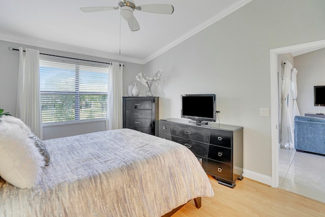 bedroom featuring ceiling fan, ornamental molding, and light hardwood / wood-style flooring