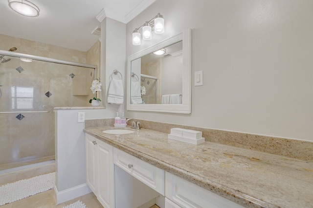 bathroom with vanity, crown molding, tile patterned floors, and a shower with door