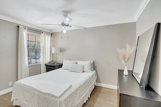 bedroom featuring ceiling fan, ornamental molding, and light hardwood / wood-style flooring