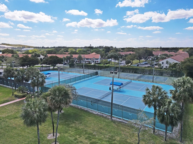 view of sport court with a yard