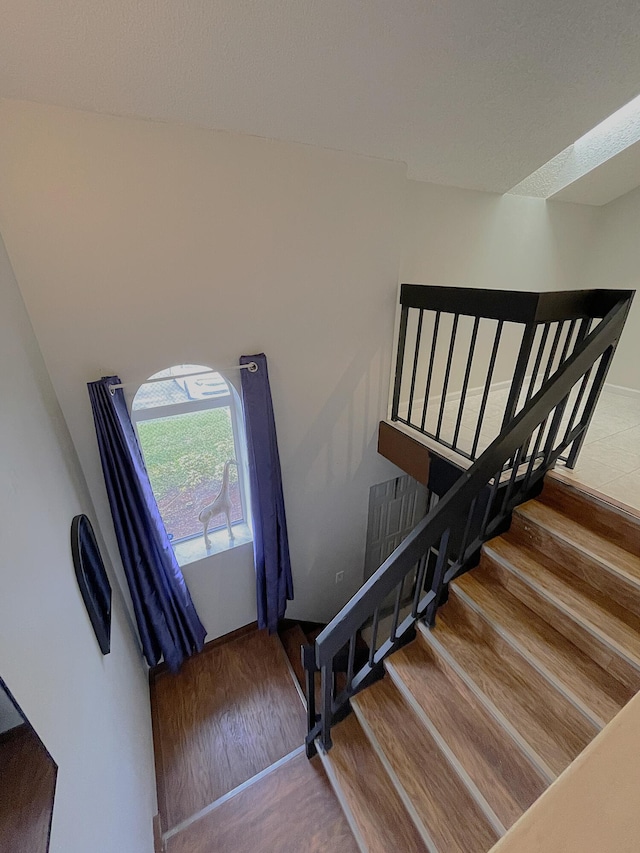 stairway featuring hardwood / wood-style flooring