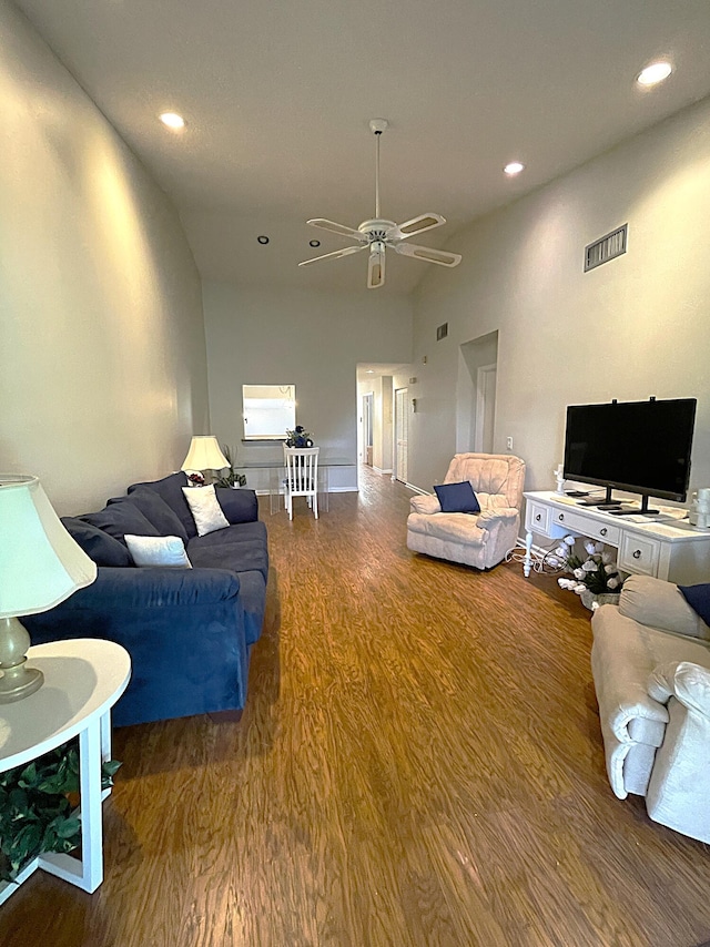 living room featuring wood-type flooring, vaulted ceiling, and ceiling fan