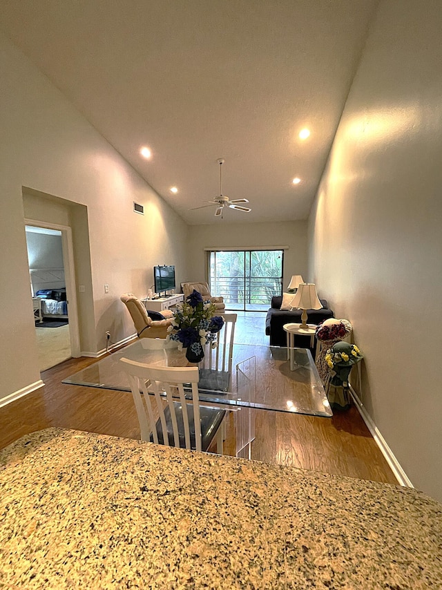 interior space with vaulted ceiling, wood-type flooring, and ceiling fan