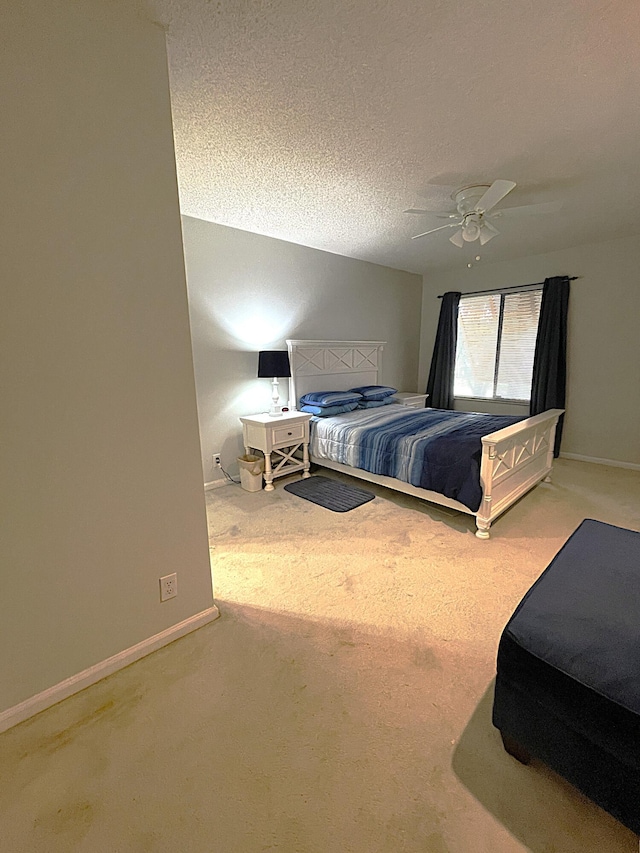 carpeted bedroom with a textured ceiling and ceiling fan