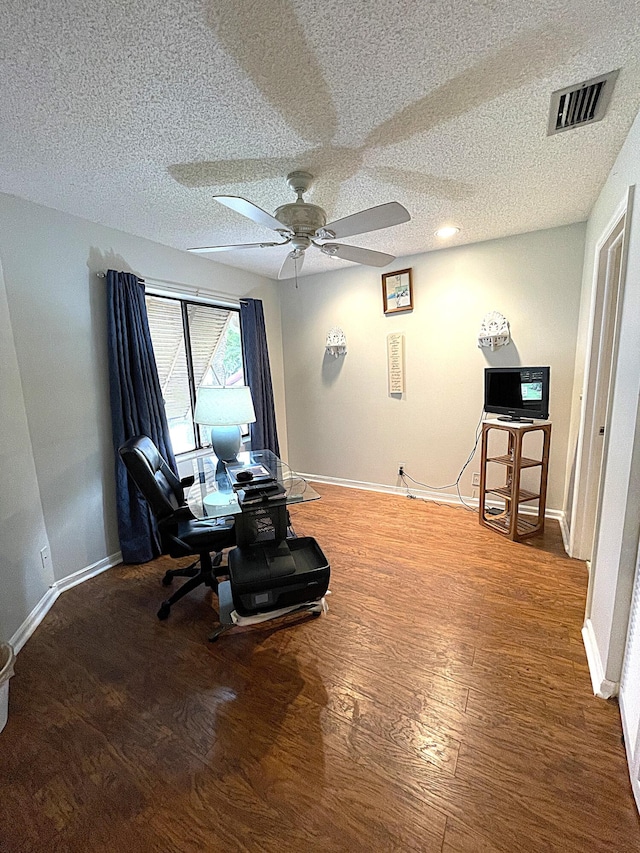 interior space featuring a textured ceiling, hardwood / wood-style flooring, and ceiling fan