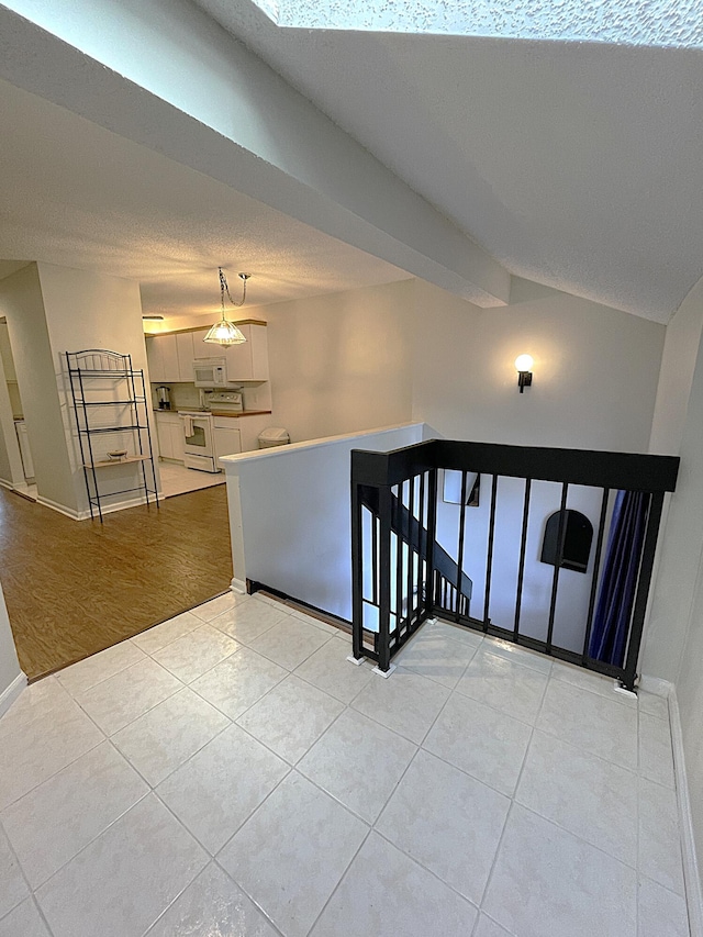 stairway featuring a textured ceiling and wood-type flooring