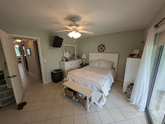 tiled bedroom with a textured ceiling and ceiling fan