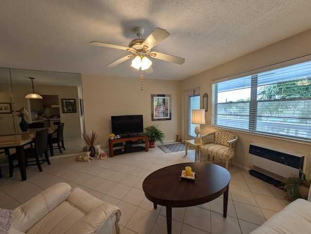 tiled living room featuring ceiling fan and a textured ceiling