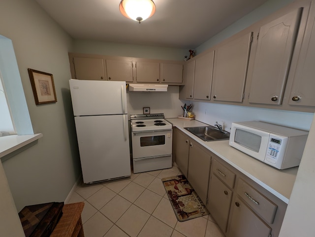 kitchen featuring light tile patterned flooring, sink, and white appliances