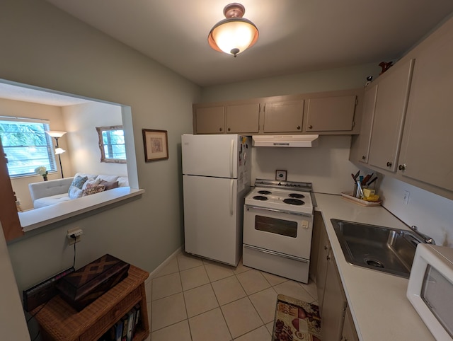 kitchen featuring sink, light tile patterned floors, and white appliances