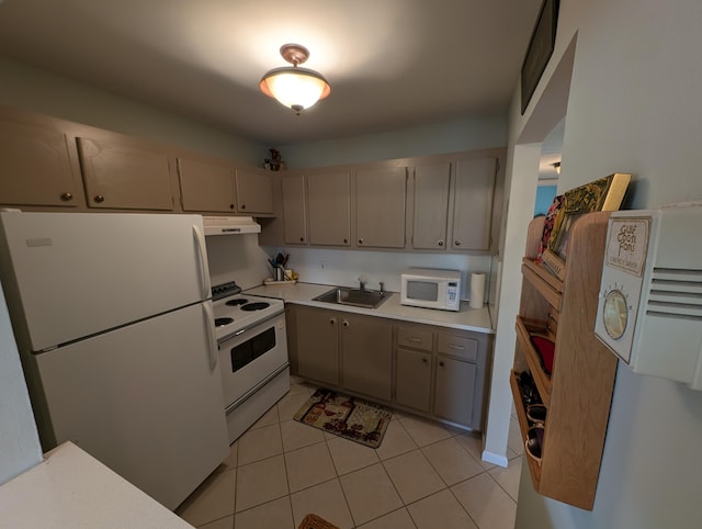 kitchen featuring sink, light tile patterned floors, and white appliances