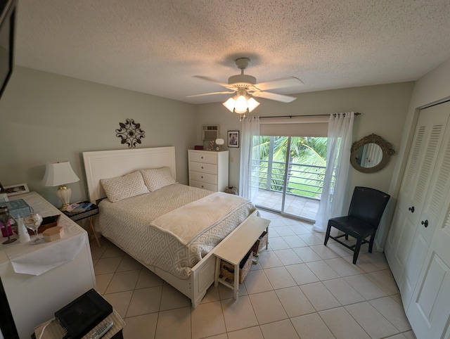 bedroom featuring light tile patterned floors, ceiling fan, a closet, and access to outside