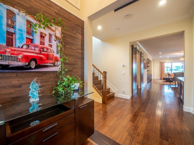 hallway with ornamental molding and wood-type flooring