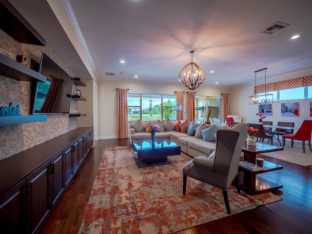 living room with ornamental molding, an inviting chandelier, and dark hardwood / wood-style flooring