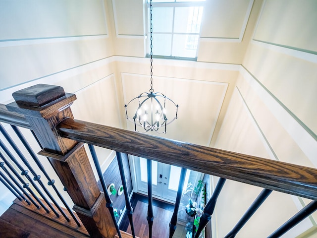 staircase featuring a chandelier and wood-type flooring