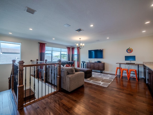 living room with hardwood / wood-style flooring and a chandelier