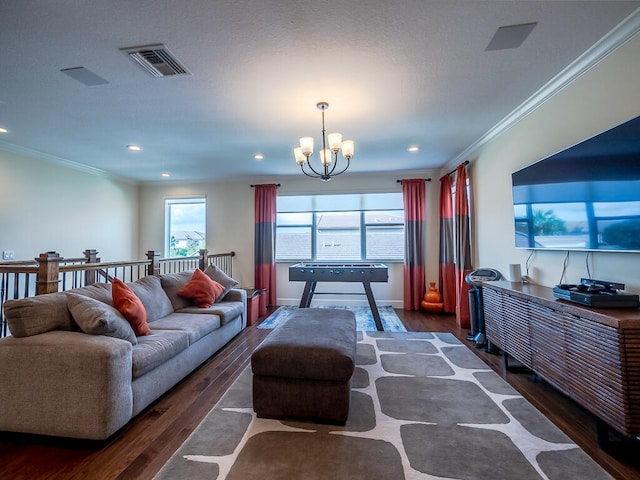 living room featuring ornamental molding, a chandelier, and dark hardwood / wood-style floors