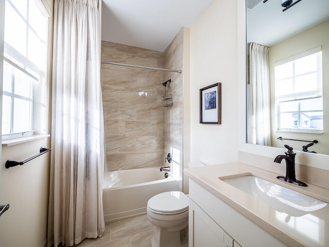 full bathroom featuring toilet, shower / bath combo with shower curtain, and vanity