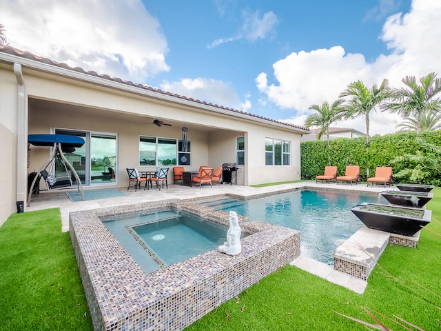 view of swimming pool featuring an in ground hot tub, a patio area, a lawn, and a grill