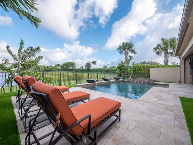 view of pool with pool water feature and a patio