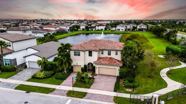 aerial view at dusk with a water view