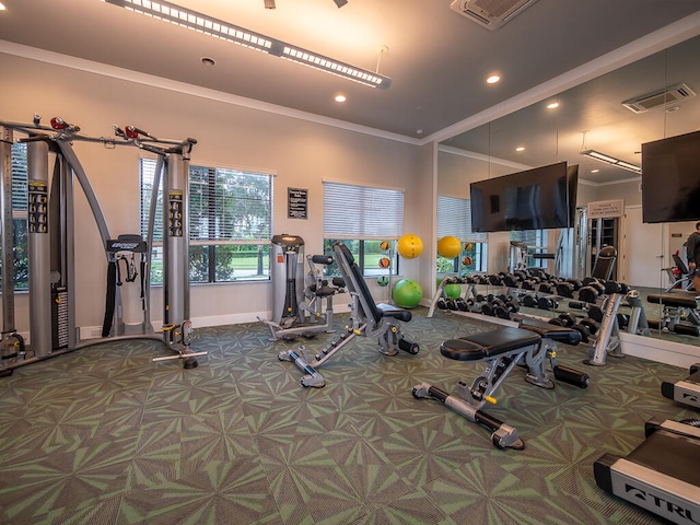 gym with ornamental molding and carpet floors