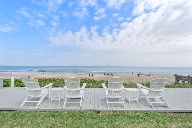 view of patio / terrace featuring a water view and a beach view