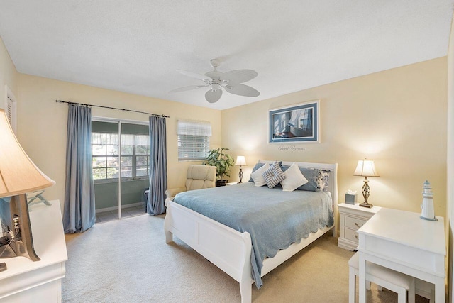 carpeted bedroom with a textured ceiling and ceiling fan