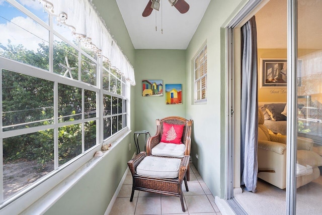 sunroom featuring ceiling fan