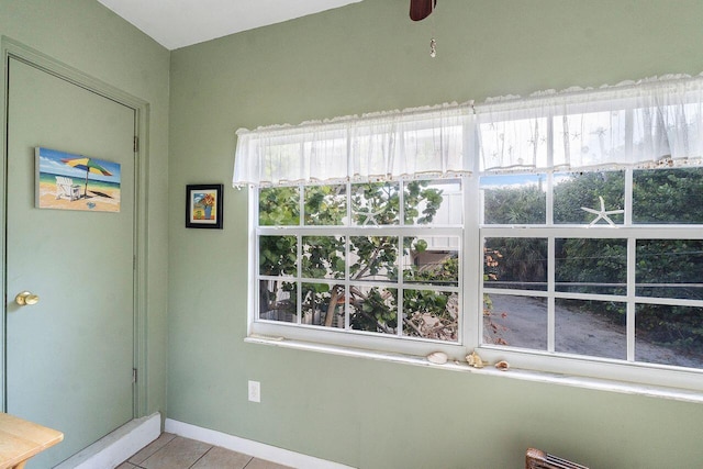 interior space featuring tile patterned floors and ceiling fan