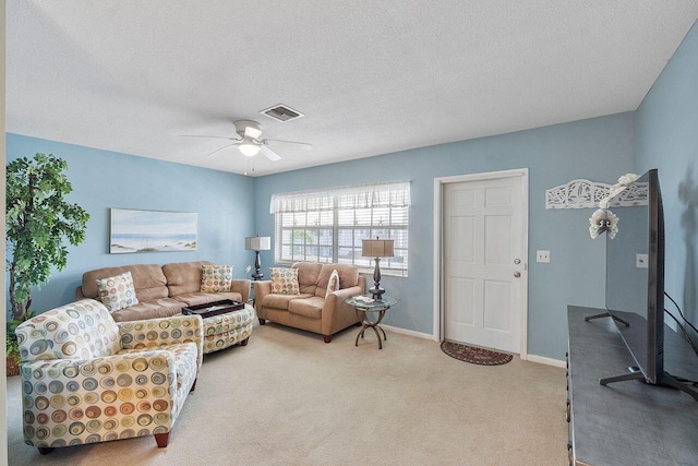 carpeted living room featuring a textured ceiling and ceiling fan