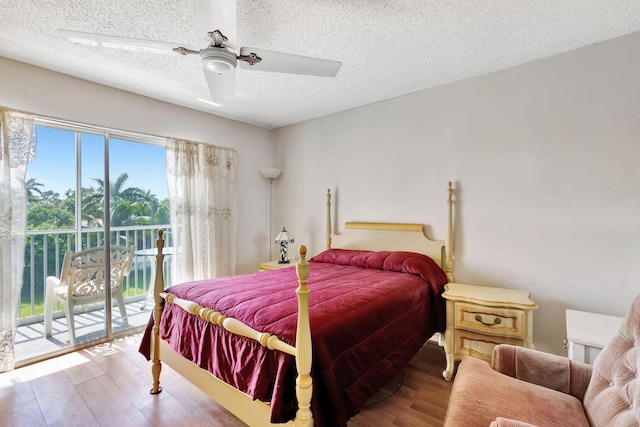 bedroom with light hardwood / wood-style floors, a textured ceiling, access to exterior, and ceiling fan