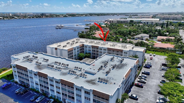 birds eye view of property with a water view