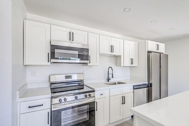 kitchen featuring white cabinets, stainless steel appliances, and sink