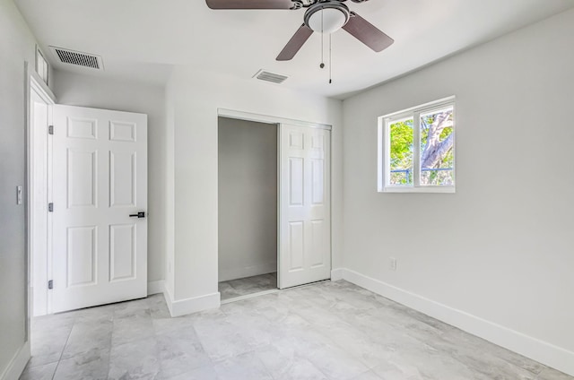 unfurnished bedroom featuring ceiling fan and a closet