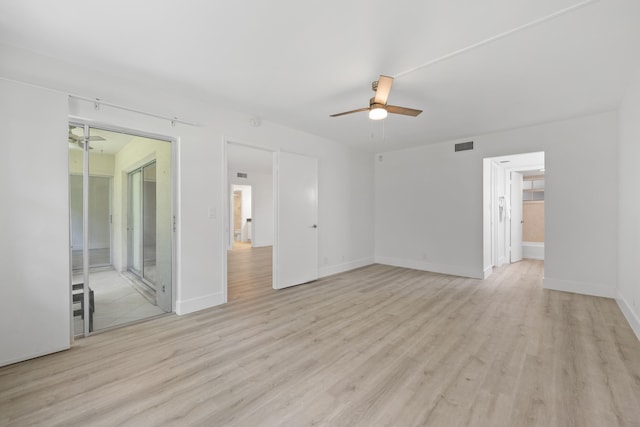 empty room featuring light hardwood / wood-style flooring and ceiling fan