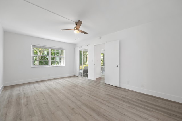 spare room featuring light wood-type flooring and ceiling fan