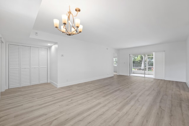 interior space with a chandelier and light hardwood / wood-style flooring