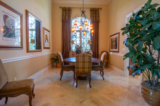 dining room with crown molding and an inviting chandelier