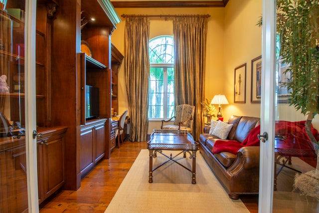 sitting room featuring ornamental molding, french doors, hardwood / wood-style floors, and a healthy amount of sunlight