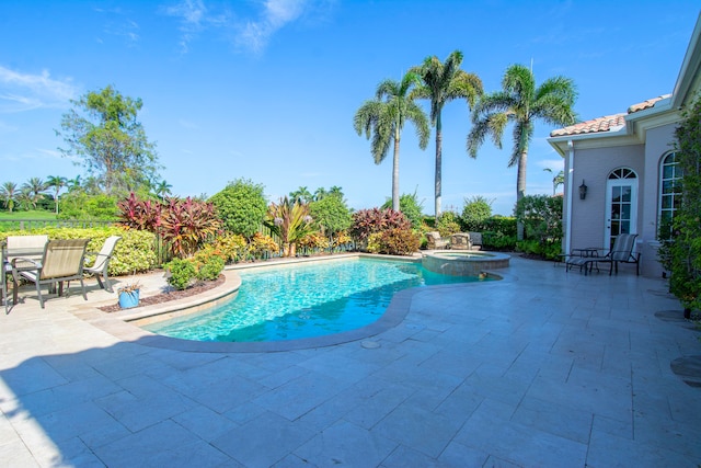 view of pool featuring an in ground hot tub and a patio area